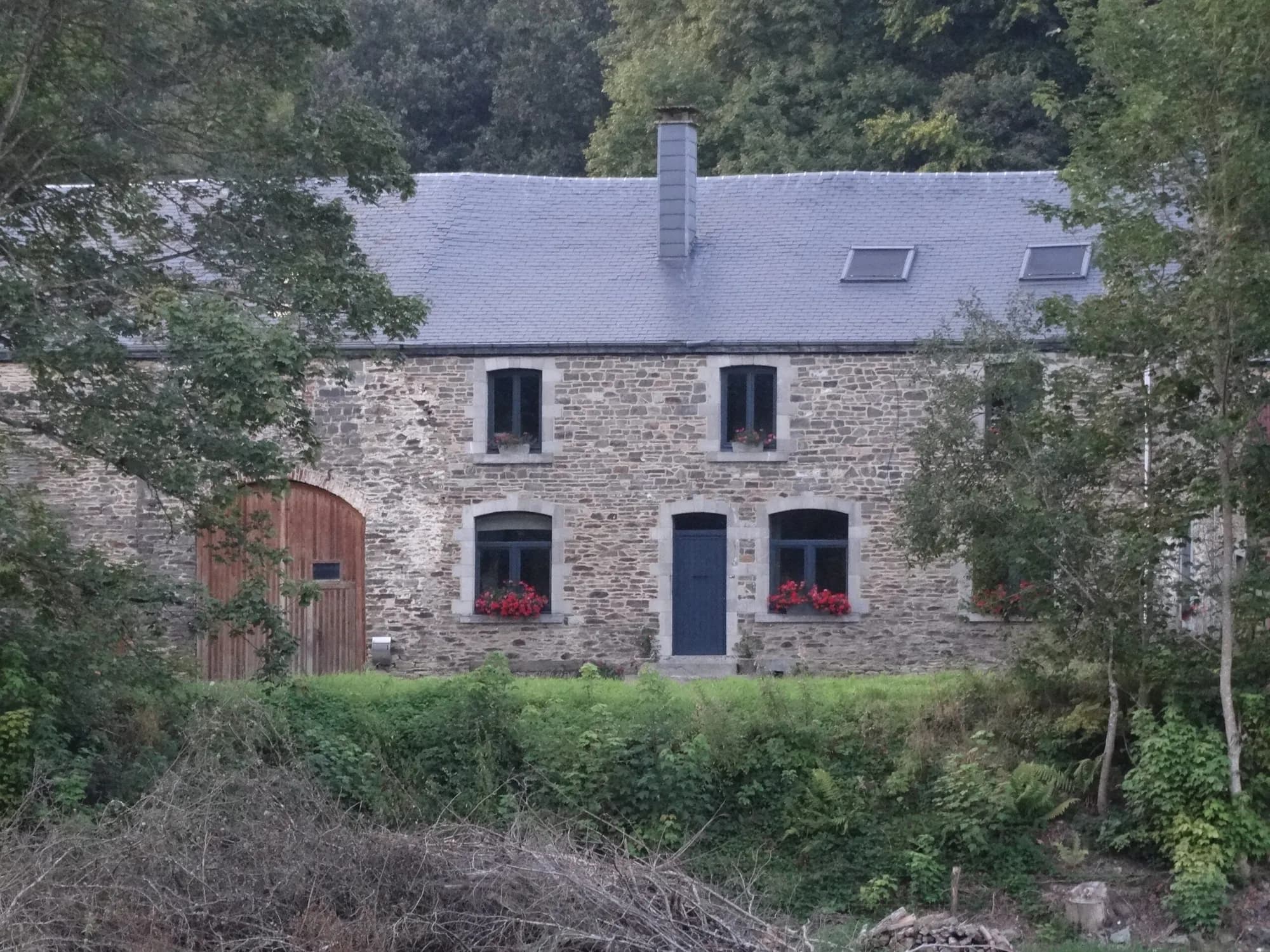 The stone facade of the former farmhouse